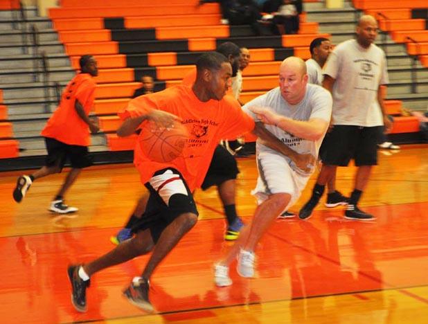 Former MHS basketball players Sherman Valentine (left) and Brent Dawkins (right) compete in the MHS Alumni Games.