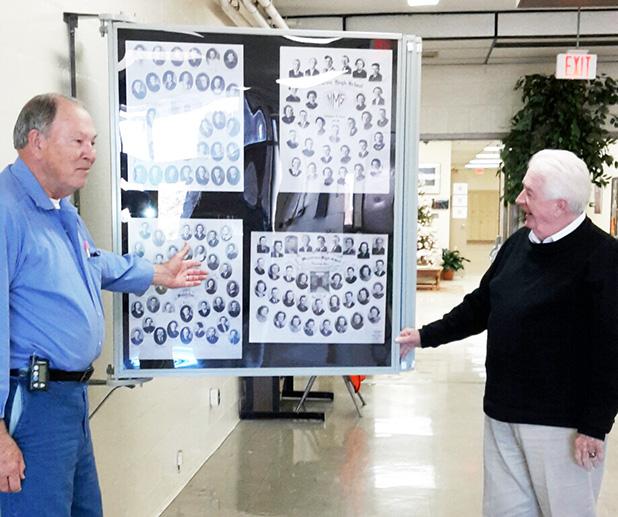 James Kirk, Vice President of CAB, and Mitch Carter of Moore’s Studio are shown discussing the completed Full-Vue Wall Display of Middleton High School senior composites displayed in the school lobby.