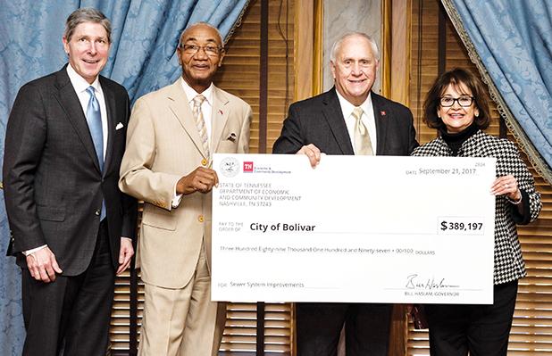 Cash Flows into Bolivar Sewers ECD Commissioner Bob Rolfe (left), Representative Johnny Shaw, Deputy Governor Jim Henry, and Senator Dolores Gresham.