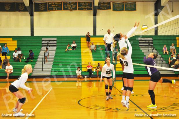 BCHS Lady Tiger Kyrayla Hunt (left) goes up for the kill as Leah Parks (background) and Becca Fulghum (right) ready to assist.