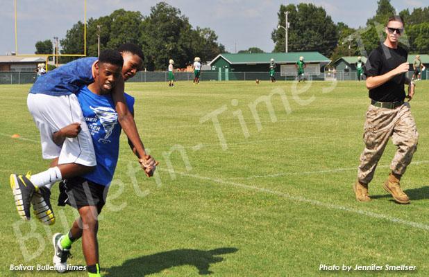 Keshawn Burkley carried his “buddy” and teammate Louis Cross during the Combat Fitness Test, as sergeant Brazil (right) looks on.