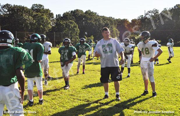 Mays leads the BMS Tigers BMS Head Football Coach Brian Mays discusses strategy with his players.