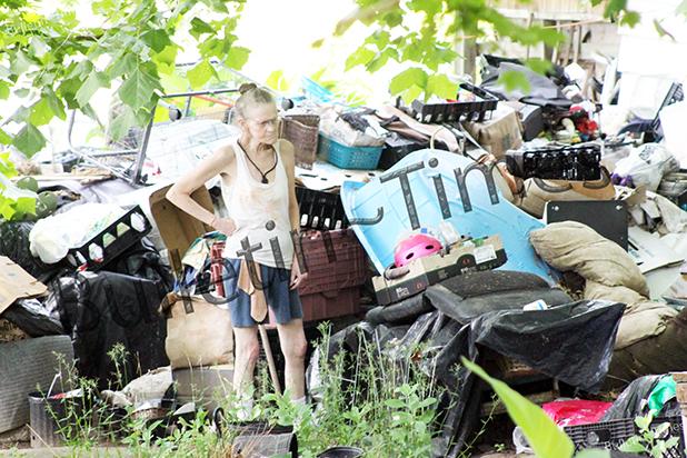 County gives Dixie Hills residents some relief Dixie Hills Resident Mary Cole stands in the midst of the garbage and items in her front yard, angry, while county employees work to clean up her property after she refused to comply with cleanup herself.