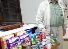 Bill Kirk, representative of Loaves and Fishes, is shown with some of the food members of the Grand Junction Ruritan Club donated after he spoke at their November meeting.