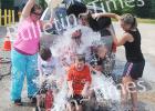 Members of the Middleton Babe Ruth 4-6 year old All Stars and their coach cool off during a car wash fundraiser for their upcoming trip to the West Tennessee State Tournament. Front row: Knox Smith. Second row, Kenny Younker, Jonathan Luttrell (head coach), Toby Hammons. Third row (parents) Lissa Younker, Jami Smith, Carlee Johnson.