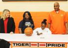 Averyale Joy signs to play basketball for Northwest Mississippi Community College. Pictured (l-r) MHS Principal Darlene Cardwell, Thella Joy (Averyale’s mother), Averyale Joy (seated) and MHS Lady Tiger Head Coach James Burkley 