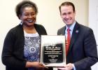 Bertha Graves receives a plaque from Mike Dunavant