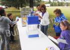 Members and friends of Grace Pointe Church in Whiteville serve up free hotdogs, pop corn and snow cones during a block party held at Whiteville Elementary School