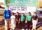 Bolivar Elementary and Bolivar Middle School received new signs for their campuses from the Hardeman County Schools. At Bolivar Elementary, school principal James Rutherford poses with students. 