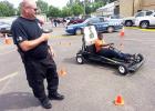 Middleton Police Department held a traffic safety day at the high school. Four enforcement agencies participated. Different displays and activities allowed students to see and experience the dangers of impaired driving. Pictured, Middleton K-9 Officer Richie Webb remotely assumes operation of the vehicle driven by student Rontavious Poplar. The officer can control the vehicle so it drives normally or simulates impaired driving as the student attempts to negotiate an obstacle course.