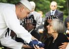 Puckett’s widow, Margaret, is presented with the folded flag from the U.S. Navy in honor of his service to the country.