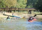A group of canoers and kayakers approach Charles T. Russell Landing and Hatchie Town River Park.