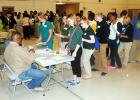 Students line up at the Bursar's office to pay for college fees during the Anycollege simulation. 