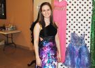 Pictured, Amber Bailey tries on one of the dresses on sale at the “A Second Dance” prom dress sale.