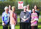 Pictured with Fulghum (center) are (left to right) staff members:  Pat Kirk, Brittany Tibodeau, Dorothy Gatewood, Fulghum, Rhonda Sipes, Michelle Johnson, and Crystal Pannell. 