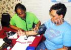 Cassandra Bufford, a RN at the Hardeman County Community Health Center takes Nikita Dennis' blood pressure during the mini health fair at Greater Victory Church on Saturday, March 12.