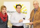 Pictured: Mary McCammon (RN with HomeChoice) and Don Young (HomeChoice Director of Operations) present the donation check to Bo Lane with Loaves and Fishes. 