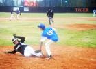 Middleton’s Hunter Dickey slides in under Hornsby Pitcher Kyle Sipes attempted tag for a score.