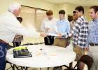 High school seniors talk with Curtis Lane of Wilson Well, Company. High school students were encouraged to attend the fair. Photo by Ginger Tester.  