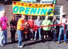  Greg Diffee (center) cuts the ribbon on his new store Joose Vapors
