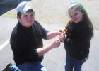 Truman Mayfield allows Bethany Hopper to hold a baby duckling at the petting zoo.