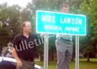 Former chief deputy, county commissioner honored Mike Lawson’s sons, Chad Lawson and Scotty Lawson unveil a sign honoring their dad, who served Hardeman County in many capacities for more than 25 years, by renaming a two mile stretch of Hwy. 125 South in his honor.