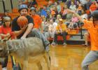 Matthew Maness tries to get on his donkey with the ball