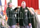Tennessee Adjutant General Major General Jeff Holmes and wife Becky Ross pin the hardware on Ross during the ceremony.