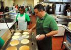 Pictured is school board member Kenny Adkins working the griddle during Pancake Day.