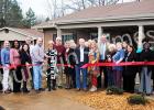 Sylvia Alexander, property manager for Ridgecrest Apartments in Bolivar cuts the ribbon officially dedicating the newly refurbished apartment complex during an open house on Dec. 16.