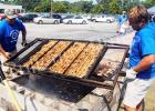 For more than 35 years, members of the Bolivar Rotary club have braved the heat of the summer to stand over a hot Bar B Q pit cooking chicken halves to help raise money for various events in the community, and year after year they sell out. About 1,000 chicken halves were sold this year, and about $6,000 was raised. Rotary members Frank Wilhite and Chris Bell begin the process of flipping about 500 chicken halves.