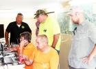 Sheriff Doolen and members of the search team watch live drone footage scanning the area. Photo by Jessica Simmons