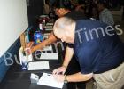 Mike Kennamore makes a bid in the silent auction at the Mid South Toys for Tots fundraiser.