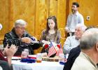 Presly Smith serves lunch to Vietnam Vets. Many students on Spring Break helped serve and bus tables. Photo by Ginger Tester. 