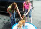 Charley Weaver and Charly Green wash Partner during Saturday's dog wash. 