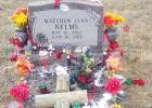 Kailey Tillmon is pictured at her baby brother’s grave after her letter to Santa was answered on Christmas and Santa left some treats for her baby brother on his grave.