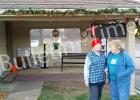 Wanda Culver, left, and Louise Watkins, members of the Grand Valley Lakes Ladies Club are shown outside the community’s guard shack. These volunteers decorated the building as part of the club’s Christmas season activities.