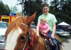 Even the young can enjoy the ride. Kaitlyn Howell takes one year old Cheyenne Phelps for a quick ride.