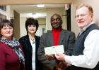 In their continued commitment to the community, President Tommy Sain (right) presents Merchants & Planters Bank’s annual contribution to members of the HCIL Board of Directors, Jackie Hickey, Cathy Mayfield and Monroe Woods. 