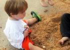 Eli Woods digs for quarters in the sawdust pile at the Children’s Patriotic Festival.