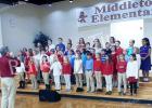 The Third and Fourth Grade students and teachers of Middleton Elementary School presented a stirring musical program to honor our veterans. Under the direction of Andrew Proctor, the students sang several patriotic songs. They honored each veteran in attendance as they sang the official hymn of each branch of military service.    