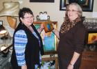 Owner Deborah Turner Brasfield (left) and local artist Jackie Smith examine a work of art. 