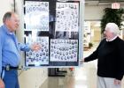 James Kirk, Vice President of CAB, and Mitch Carter of Moore’s Studio are shown discussing the completed Full-Vue Wall Display of Middleton High School senior composites displayed in the school lobby.
