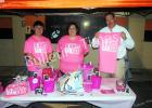 Brandon Burvee, Kathy Weaver and David Tyner sell Pink Out shirts and other items during the Middleton Homecoming game. 