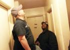 Charles Thompson (left) inspects the smoke alarm he has just installed as Property Manager James Woods looks on. This alarm was one of over 100 installed in Bolivar in just one day. 