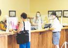 Early voters on July 17 prepare to vote.
