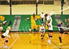 BCHS Lady Tiger Kyrayla Hunt (left) goes up for the kill as Leah Parks (background) and Becca Fulghum (right) ready to assist.
