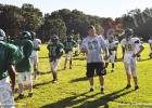 BMS Head Football Coach Brian Mays discusses strategy with his players.