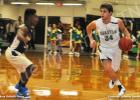 BCHS wins one and loses one BCHS Tiger Kaleb McKinnie takes the ball down the court against Arlington.