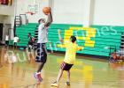 Willie Kemp shoots basketball with one of the basketball campers at the annual Willie Kemp Basketball Camp.